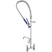 A chrome Waterloo pre-rinse faucet with blue handles and a hose.