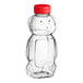 A 16 oz. clear plastic Bear PET honey bottle with a red cap.