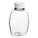 An 8 oz. clear PET plastic Queenline honey bottle with a white cap.