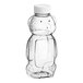 A clear plastic Bear PET honey bottle with a white lid.