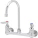 A chrome T&S wall mount faucet with dual lever handles.