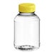 A clear plastic 8 oz. Skep PET sauce/honey bottle with a yellow lid.
