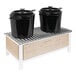 A Cal-Mil maple wood chafer alternative rack holding two black pots with lids.