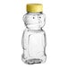 A clear plastic bear-shaped bottle with a yellow cap.