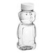 A clear plastic Bear PET honey bottle with a white cap.