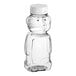 An 8 oz. clear plastic Bear PET honey bottle with a white flip top lid.