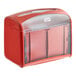 A red plastic Tork Xpressnap tabletop napkin dispenser with a clear plastic lid.