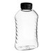 A clear plastic ribbed hourglass honey bottle with a black plastic flip top lid.