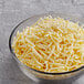 A bowl of Violife Just Mozzarella vegan cheese shreds.