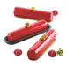 Three red cylinder desserts made with the Silikomart Curve Cylinder silicone baking mold.