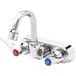 A T&S chrome wall mount faucet with two knobs.
