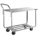 A silver Winholt stocking cart with black wheels and two shelves.