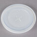 A close-up of a white plastic lid with a cross.