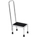 A black and silver Vestil step stool with a hand rail.
