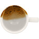 A RAK Porcelain brown espresso cup filled with brown liquid.