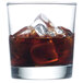 A glass of brown liquid with Manitowoc regular size ice cubes.