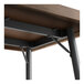 A close up of a Lancaster Table & Seating bar height table with metal legs.