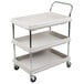 A gray Metro plastic utility cart with three shelves and black handles on wheels.