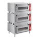 A stack of silver Avantco triple deck countertop bakery ovens.