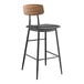 A Lancaster Table & Seating black bar stool with a wood backrest and black vinyl seat.