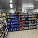A store room with B-O-F Corporation VersaRack beer shelving filled with bottles of alcohol.