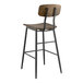 A Lancaster Table & Seating butcher block bar height chair with a black metal frame and wood seat and back.