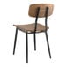 A Lancaster Table & Seating black mid-century chair with wood seat and backrest.