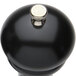 A black pepper mill with a silver knob.
