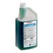 A bottle of SC Johnson Professional Quaternary Disinfectant Cleaner, a gallon of green liquid with a white lid.