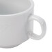 A close-up of a CAC Super White porcelain coffee mug with a handle.