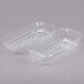 A couple of Dart ClearSeal clear plastic hoagie containers with lids.