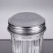 A Tablecraft fluted glass salt and pepper shaker with a stainless steel top.