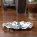 A silver Royal Paper aluminum foil ash tray with a silver star design on a table.