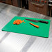 A Tablecraft flexible cutting board with a knife and carrots on it.
