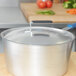 A Vollrath aluminum pot lid with a Torogard handle on a metal surface.