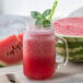A glass jar of red Smartfruit Wild Watermelon drink.