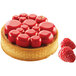 A dessert with raspberries on top in a Silikomart Tarte Ring Paradis.