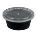 A Pactiv Newspring black oval plastic souffle cup with a clear lid.