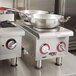An APW Wyott stainless steel countertop electric range with two pots on it.
