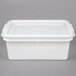 A white plastic Vollrath perforated drain box with a lid.