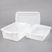 Two white plastic Vollrath perforated drain boxes with lids.