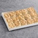 A white box of Pillsbury Easy Split Baked Golden Buttermilk Biscuits on a gray surface.