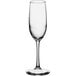 A close-up of a clear Libbey Vina flute wine glass with a long stem.