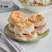 A plate of Pillsbury Easy Split Baked Golden Buttermilk Biscuits with ham and cheese.