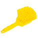 A yellow Carlisle Sparta utility brush with long bristles and a handle.
