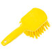 A close up of a yellow Carlisle Sparta pot scrub brush with a handle.