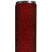 A red cylinder with a black top containing a roll of crimson Notrax carpet.