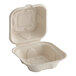 A white World Centric compostable fiber burger clamshell with a lid.