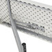 A National Public Seating white plastic seminar table with speckled gray details and holes in the top.