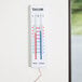 A Taylor 5327 indoor / outdoor thermometer on a wall.